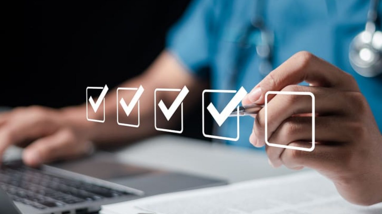 Doctor fills out the medical survey paperwork and checking mark on checkboxes.